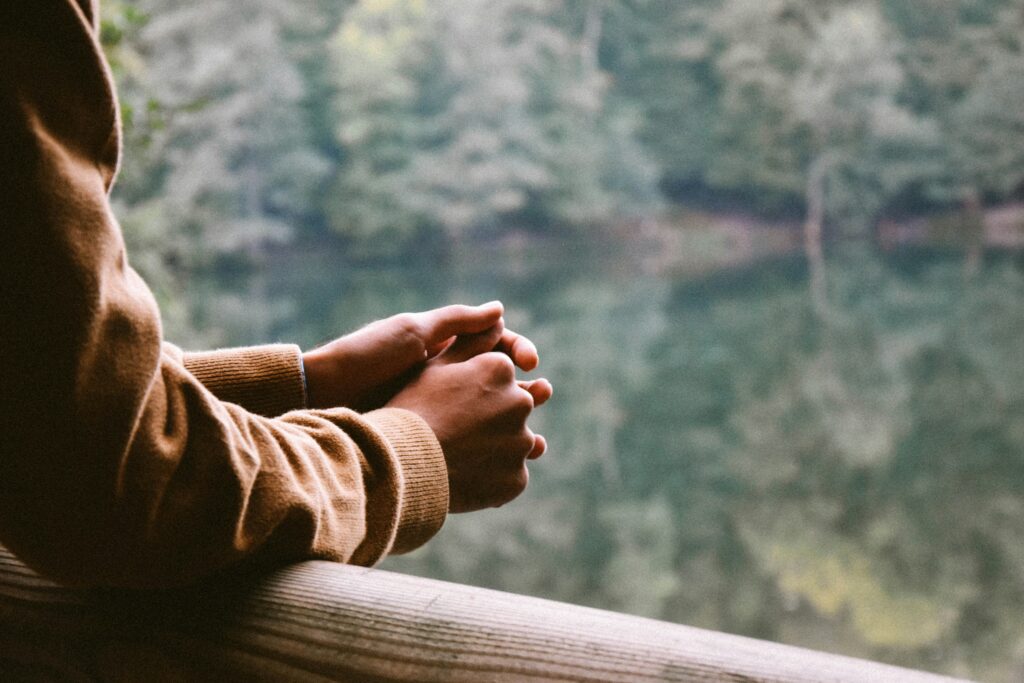 hands together overlooking nature